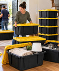 Rock Solid Heavy Duty Storage Totes With Secure Lids 27 Gallon 4 Pack Stackable Plastic Bins 100 Pound Capacity in living room.