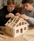 Two teens constructing a dollhouse using 25 Pack Square Wood Dowel Rods 5/16 X 15 Inch Unfinished Pine Craft Sticks.