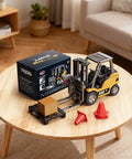 Mini RC Forklift Toy With Remote Control 2.4GHz 2 In 1 Lift Fork And Hook Truck next to box on table