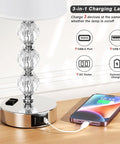 Crystal Table Lamp Set of 2 With USB A and USB C Ports and 2 Pin Outlet, charging phone on wooden table, 14.6 inch tall.