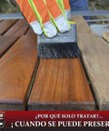 Applying Heavy Hitter Oil Based Wood Preservative And Exterior Stain In Warm Pecan Hue to wooden planks with a brush.