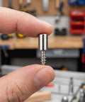Hand holding a metal peg from Self Tapping Shelf Pegs and Screws Set, 150 Pcs, 0.3 Inch Cabinet Pins With Sleeves For Laminate Shelves