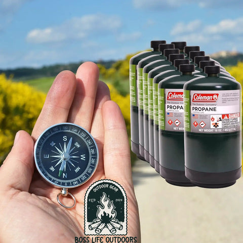 Hand holding compass with 12 Pack 16 Ounce Propane Cylinders For Camping And Outdoor Cooking Great For Grilling On The Go Durable Steel Construction Pre Filled 1 Pound Tanks For Camp Stoves Tabletop Grills Torches Portable Propane Appliances Made In The US Fits Adapters Green in background