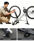 Man using Portable Clip On Bike Repair Stand 2 Pack Black With Quick Release Handlebar Support Fits 30 34mm Grips Heavy Duty For MTB Road And E Bikes Home Garage Outdoor