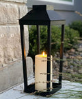 Large Outdoor Solar Powered Lantern With Open Frame No Glass Black Metal 19 Inch Tall Dusk To Dawn Timer Flickering LED Candle Lantern For Porch Patio Garden Rustic Farmhouse Vibe beside stone wall