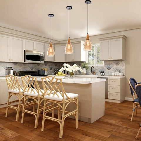 Three Pack Teardrop Glass Pendant Lights with Adjustable Nylon Core Cables Contemporary Ceiling Fixtures for Kitchen Island Dining Room and Work Area Bulb Not Included, hanging over a kitchen island.