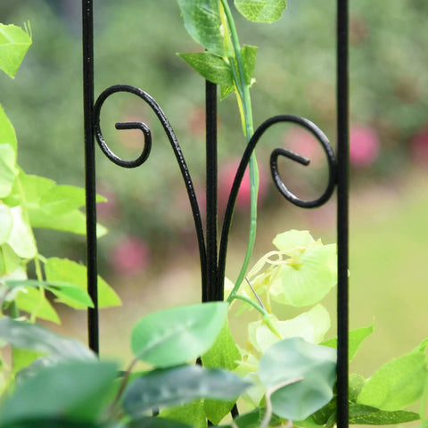 Detail of black metal trellis flourish with green foliage for Outdoor Garden Arbor Arch Gate With Trellis Sides For Climbing Plants