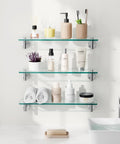 Sturdy 20 Inch Glass Wall Shelves 3 Pack With Rectangular Stainless Steel Brackets In Brushed Finish mounted with toiletries