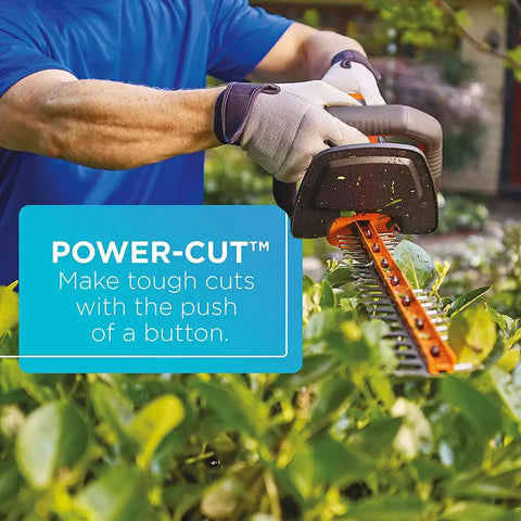 Person using the 20V Max Cordless Hedge Trimmer With Power Command Powercut, 22 Inch Dual Action Blade for smooth cuts in garden.