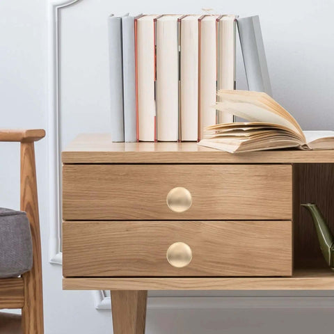 Gold Zinc Alloy Cabinet Pull Handle, Single Hole Door Pull For Wardrobe And Drawer on wooden drawer with books
