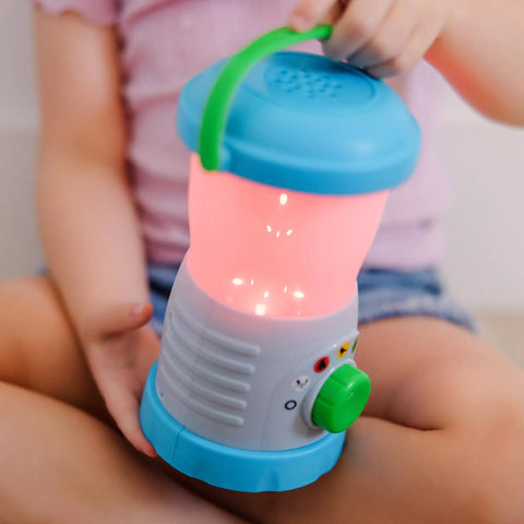 Child holding Durable Light And Sound Camping Lantern Toy With Six Color Modes and Cool Sound Effects for Kids, pink light mode