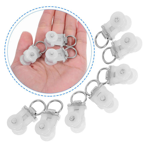 Thirty Pack Of Heavy Duty Double Wheel Curtain Track Rollers Made To Slide Like Butter On Overhead Ceiling Pulleys in hand.