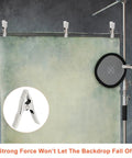 Beastly Grip Heavy Duty 4 Inch Spring Clamps securing backdrop with white protective sleeves in studio setup