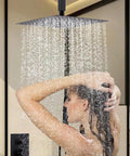 Shower Faucet Set, 12-Inch Rainfall Head, Handheld and Valve, Matte Black with water cascading down over a person.