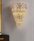 European Style Indoor Wall Sconce Featuring Cut Crystal Accents And Brushed Metal Frame For Hallways Bedrooms Or Living Rooms Delivers Smooth Ambient Lighting To Level Up Your Home Decor Game Tonight, showcasing elegant crystal details and warm lighting.