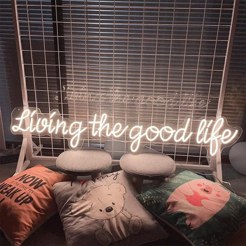 Living The Good Life LED Neon Sign Custom Personalized Home Wall Decor Large 30 Inch Indoor Light with warm white glow on grid.