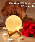 Large Moon Lamp 7.1-Inch with Wooden Base, romantic setting with candles and red roses