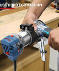 Person using Compact Wood Router Kit With 6.5 Amp 1.25 HP Power 32000 RPM Handy Beginner Friendly DIY Trim Router on wood surface.