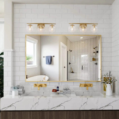 Bathroom scene with Gold Three Light Vanity Fixture With Clear Glass Globe Shades For Bathroom Modern Soft Gold Finish 22 Inch Long Vanity