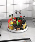Kitchen counter with Lazy Susan Turntable Organizer 10 Inch 360 Degree Rotating Tray, holding various bottles and jars.