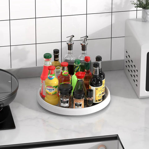 Kitchen counter with Lazy Susan Turntable Organizer 10 Inch 360 Degree Rotating Tray, holding various bottles and jars.