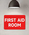 First Aid Room 8x12 Aluminum Safety Sign For Indoor Outdoor Use on wall under lamp, Medical Emergency Facility Plaque.