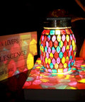 Colorful Outdoor Mosaic Lanterns Solar Powered Hanging Lights illuminating a tabletop, rechargeable mason jar style, warm white glow, waterproof
