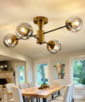 Modern Four Light Gold Glass Globe Ceiling Light Fixture mid century semi flush mount in dining room.