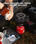 All Purpose Camping Cookware Mess Kit with hard-anodized aluminum pot on portable stove, hands pouring drink