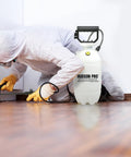 Technician using 1.5 Gallon Bleach Sprayer With Durable Viton Seals for home cleaning, portable and leak resistant, targeting tight spots.