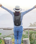 Person wearing Lightweight Packable Hiking Daypack 10L/15L Foldable Outdoor Backpack for travel on scenic overlook