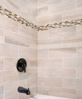 Middleton II Transitional Single Handle Shower Valve Trim with Escutcheon in oil rubbed bronze on tiled bathroom wall.
