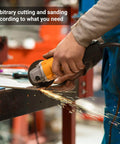 Person using an angle grinder to cut metal on a workbench creating sparks in a workshop setting