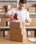 Person sealing Assorted Shipping Boxes 30 Pack Value Pack With 10 Of Each Size 10x7x5, 9x6x4, And 8x6x4 in storage area