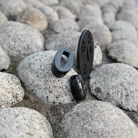 Dope Samurai Sword Tsuba Fuchi Kashira Menuki Iron Set TDZH02 displayed on stone surface, classic round tsuba, iron alloy material.