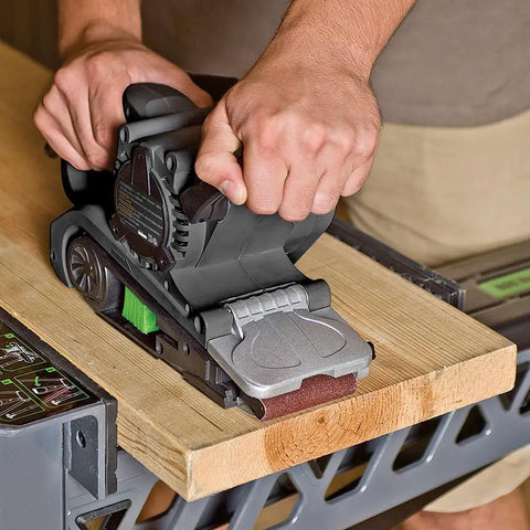 Single Lever Belt Sander 3 Inch By 21 Inch Variable Speed With Quick Change Belt Adjustable Front Handle Dust Collection Bag Grey in use on wood