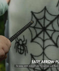Child pulling arrow from Large Archery And Crossbow Target For 400 FPS Easy Arrow Removal Durable Spylar Facing Weatherproof Cover.