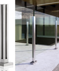 Built Different Stainless Steel Glass Railing Posts With Square Tube Design And Adjustable Heights For Indoor Hallways Outdoor Decks Pool Areas And Stairs Featuring A Rust Proof Brushed Finish. Square tube post beside glass panel.