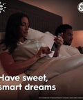 Couple in bed using smartphone to control Cync Smart LED Bulbs With Color Changing Lights Bluetooth And WiFi Control No Fuss Setup Plug And Play Works With Alexa And Google Home PAR38 Outdoor Floodlight Bulbs Four Pack Easy App Setup.