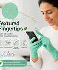 Kickass Sustainable Nitrile Gloves In Vibrant Green being used on a smartphone, showcasing textured fingertips and ambidextrous design.