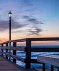 Traditional Style Outdoor Post Light With Clear Beveled Glass Panels In Black Finish, 120V 60W on scenic boardwalk at sunset