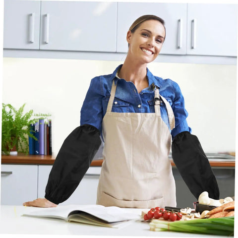 Woman in kitchen wearing Heavy Duty Grease Resistant Long Arm Sleeves Waterproof Forearm Shields while cooking.