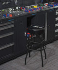 Heavy-Duty Steel Garage Shop Stool With Swivel Cushion Seat, Four Sturdy Legs, 360 Degree Foot Rings, Black Powder Coated Frame And Footrest, Single Pack in a workshop setting.