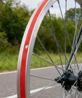 Close-up of a bike wheel with Two Pack 29 Inch Rim Tape For Road And Mountain Bikes, 13mm Wide, 0.5mm Thick, PVC Rim Strip Tape, Red Color.