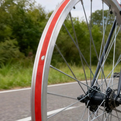 Close-up of a bike wheel with Two Pack 29 Inch Rim Tape For Road And Mountain Bikes, 13mm Wide, 0.5mm Thick, PVC Rim Strip Tape, Red Color.