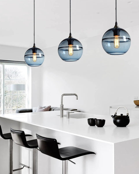 Hand Blown Glass Pendant Lights In Modern Blue With Brushed Nickel Globes, Ideal For Kitchen Island Or Dining Room Table, 7.4 Inch Diameter, Three Pack Set For Easy, High Impact Ambience displayed above a modern kitchen island.