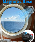 Magnetic Golf Cart Clip On Mist Fan with light attached to cruise ship window, ocean view, showcasing magnetic base.