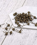 Antique Bronze Round Ball Post Stud Earrings Kit, 100 Pcs Brass Ear Pins With 1mm Loop For Jewelry Making, Vintage Style DIY Jewelry Supplies, 14.5mm Length, 12mm Width, 1.2mm Hole, brass ear pins on white board