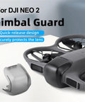 Drone Lens Cover Set For DJI NEO 2, 2 Pack Gimbal Protector Caps on table next to DJI NEO 2 drone