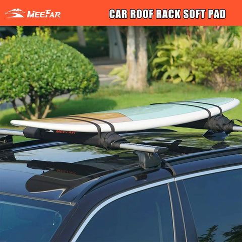 A surfboard secured on a car using Universal Car Roof Rack Pads For Kayak Surfboard SUP Canoe with heavy-duty tie-down straps.